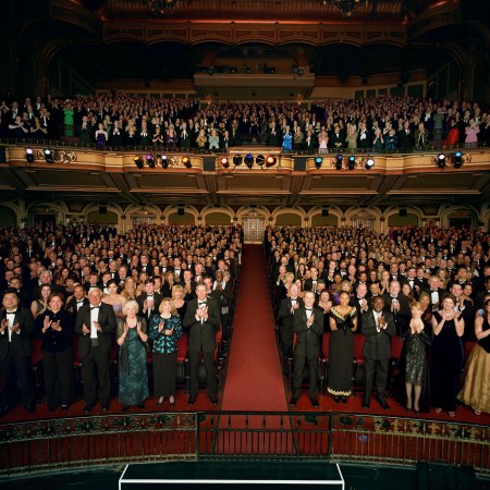 A crowd in a theater gives a standing ovation