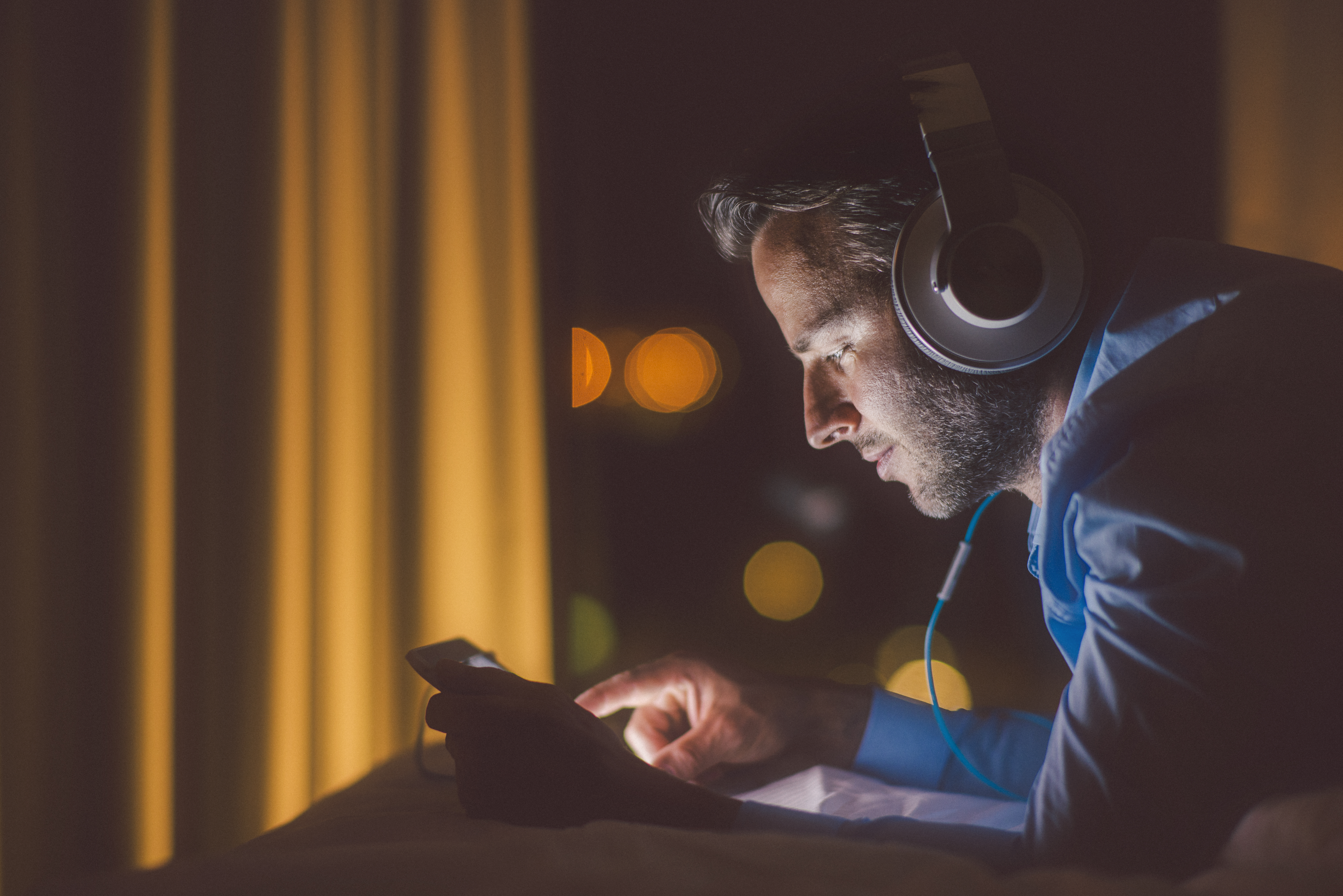 A man listens to music on headphones