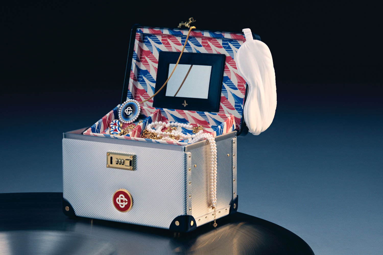 a Globe Trotter x Casablanca trunk filled against a blue background