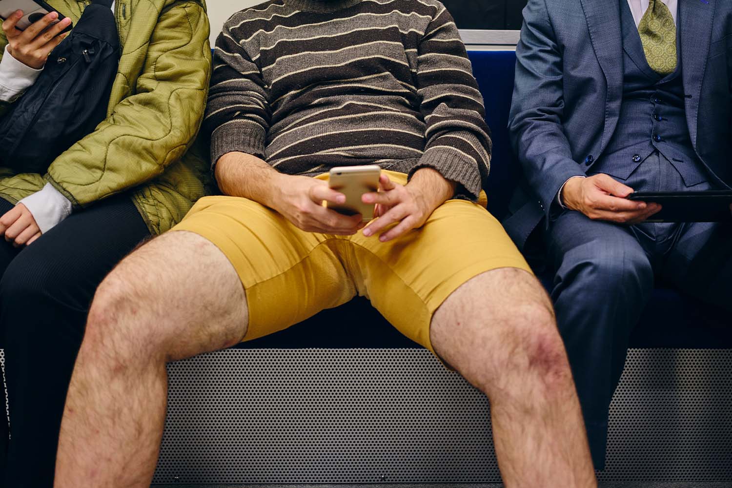 Man manspreading on a train