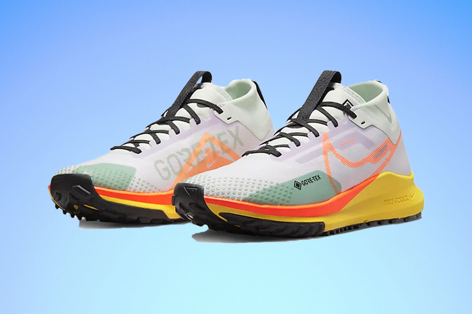 a pair of Nike Pegasus Trail 4 Sneakers on a blue gradient background