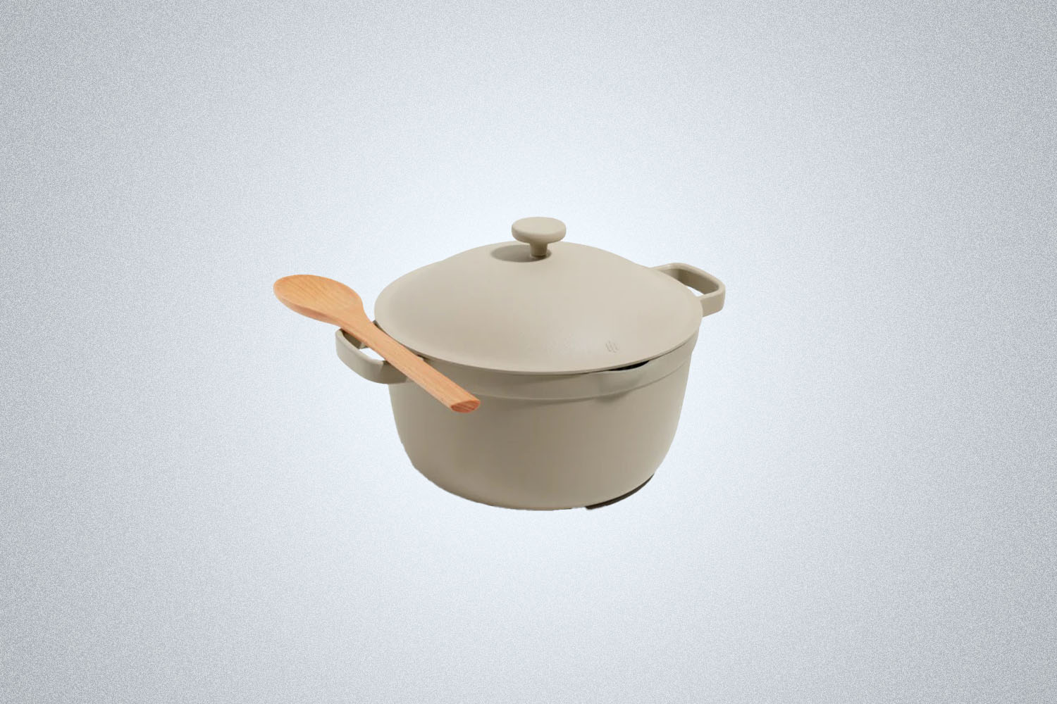 The Our Place Perfect Pot in beige on a gray background