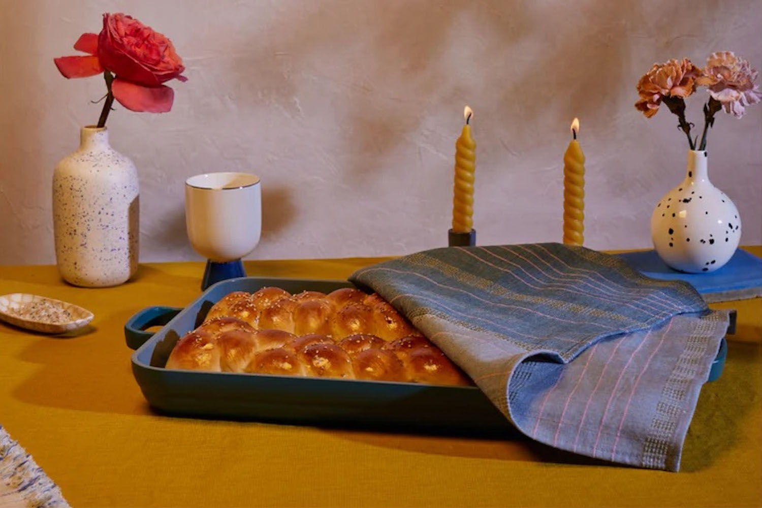 The Our Place Shabbat Set on a wooden table