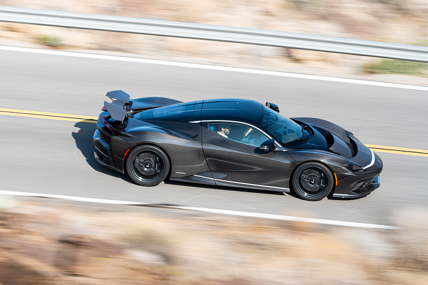 The Battista, an electric car from Automobili Pininfarina, drives down a road in the United States
