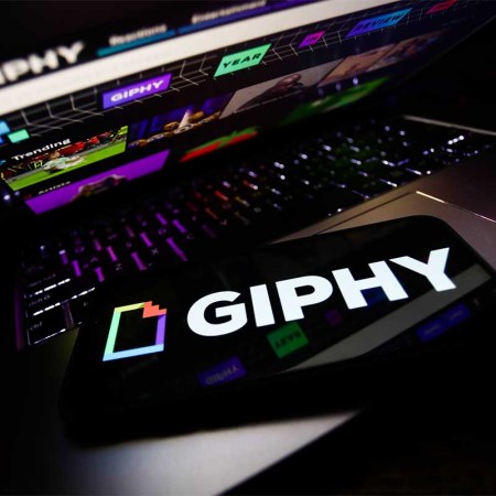 Giphy logo displayed on a phone screen and Giphy website displayed on a laptop screen are seen in this illustration photo taken in Krakow, Poland on November 29, 2021. The gif search engine is using a less than flattering self assessment to prevent a sale from being blocked to Meta.
