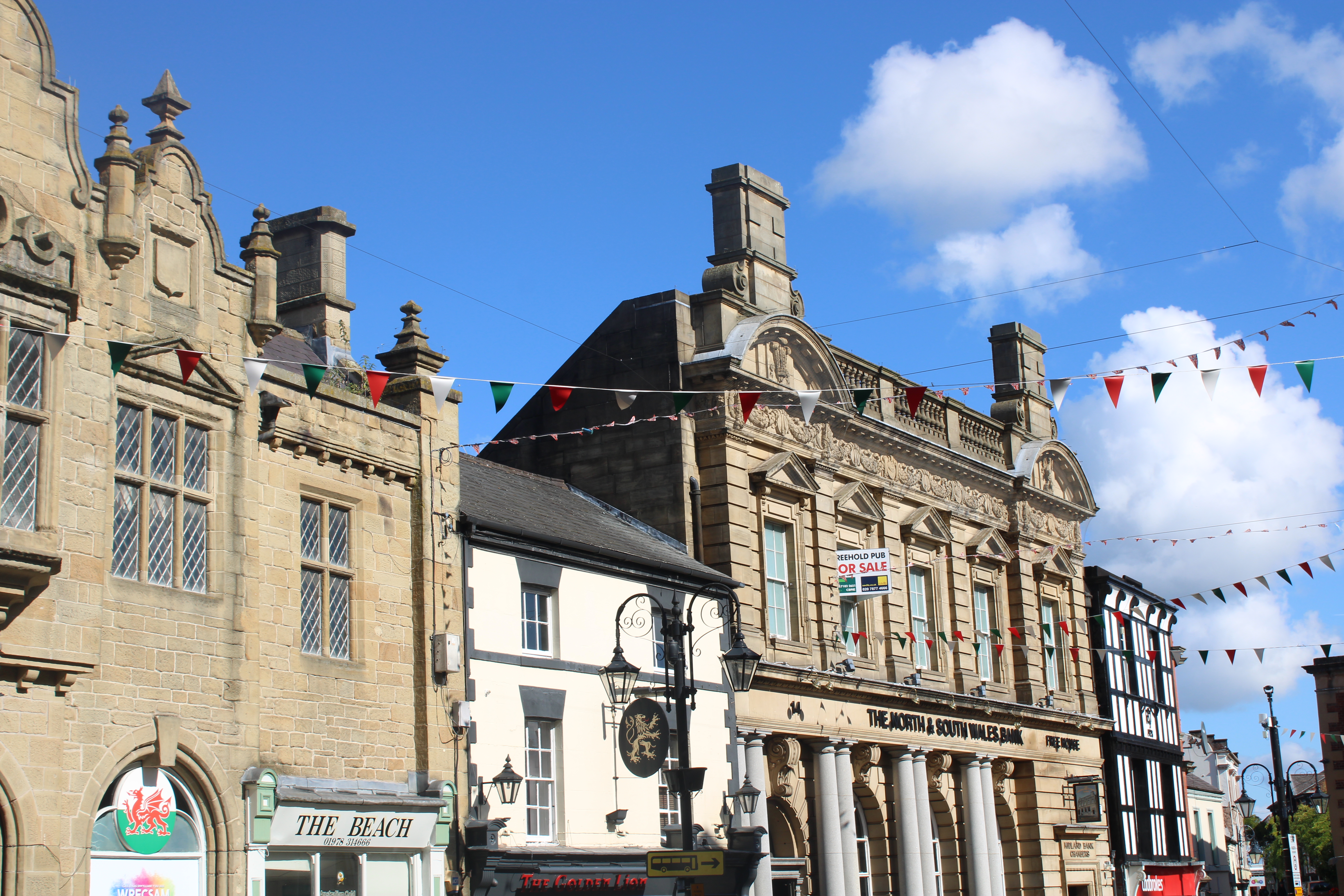 The business district in Wrexham with storefronts and pubs.