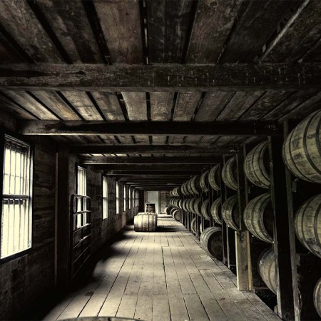 A warehouse with barrels holding booze. The location of the barrels in a warehouse can greatly alter flavor.