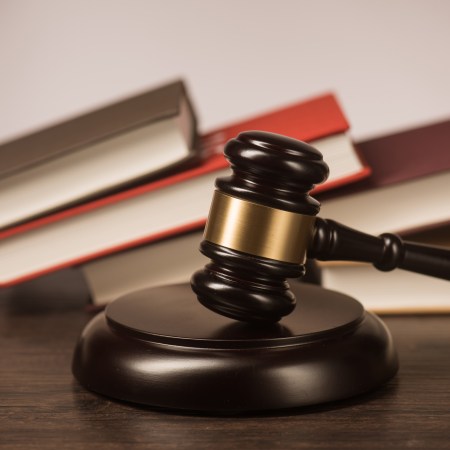 A gavel with books behind it