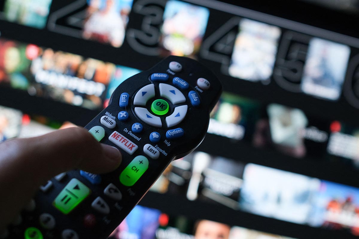 In this illustration photo taken on July 19, 2022 the Netflix logo is seen on a TV remote in Los Angeles. Netflix recently announced a new streaming plan that includes ads but is only $7.