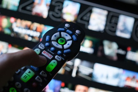 In this illustration photo taken on July 19, 2022 the Netflix logo is seen on a TV remote in Los Angeles. Netflix recently announced a new streaming plan that includes ads but is only $7.