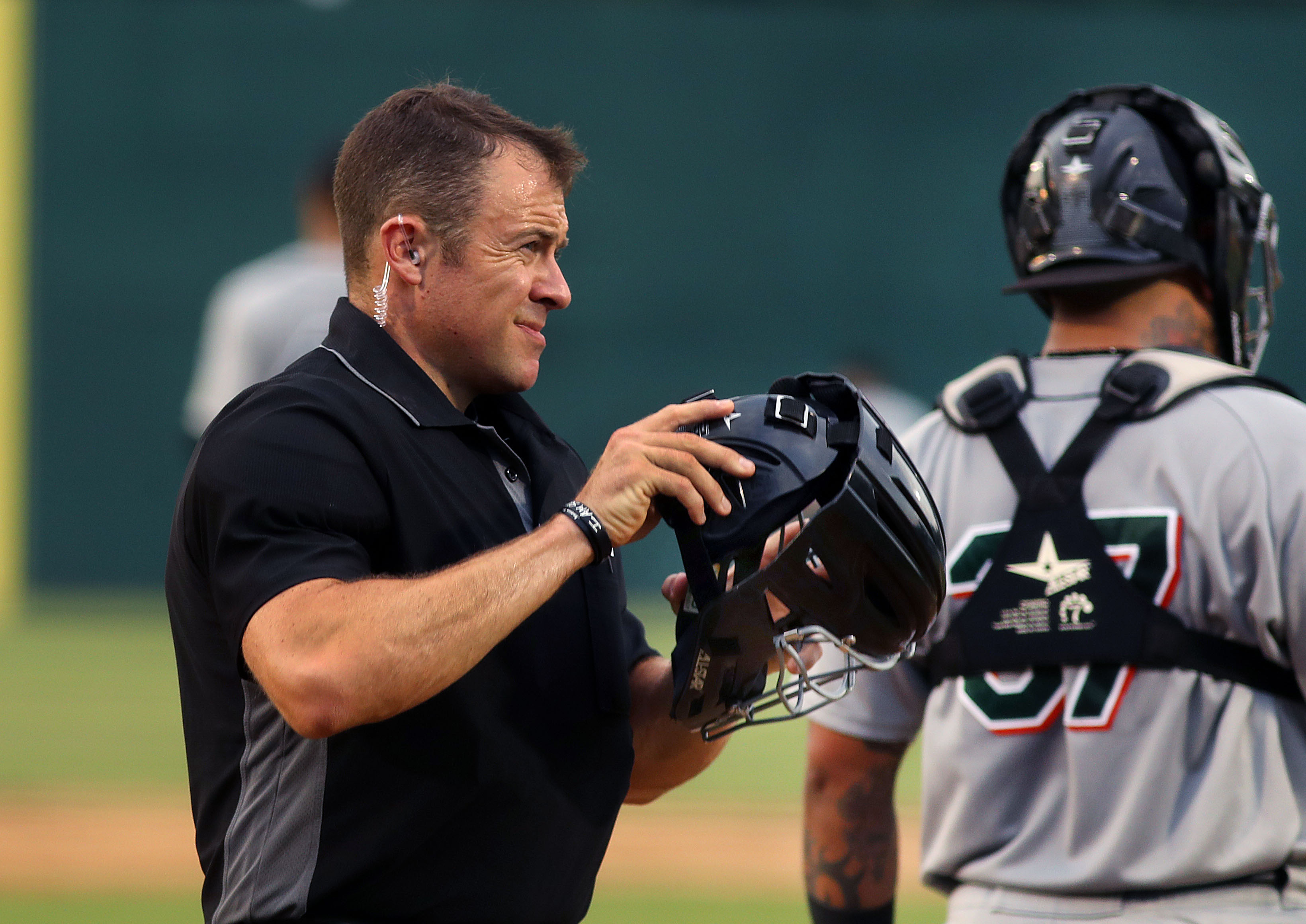 An umpire with a wire in his ear.