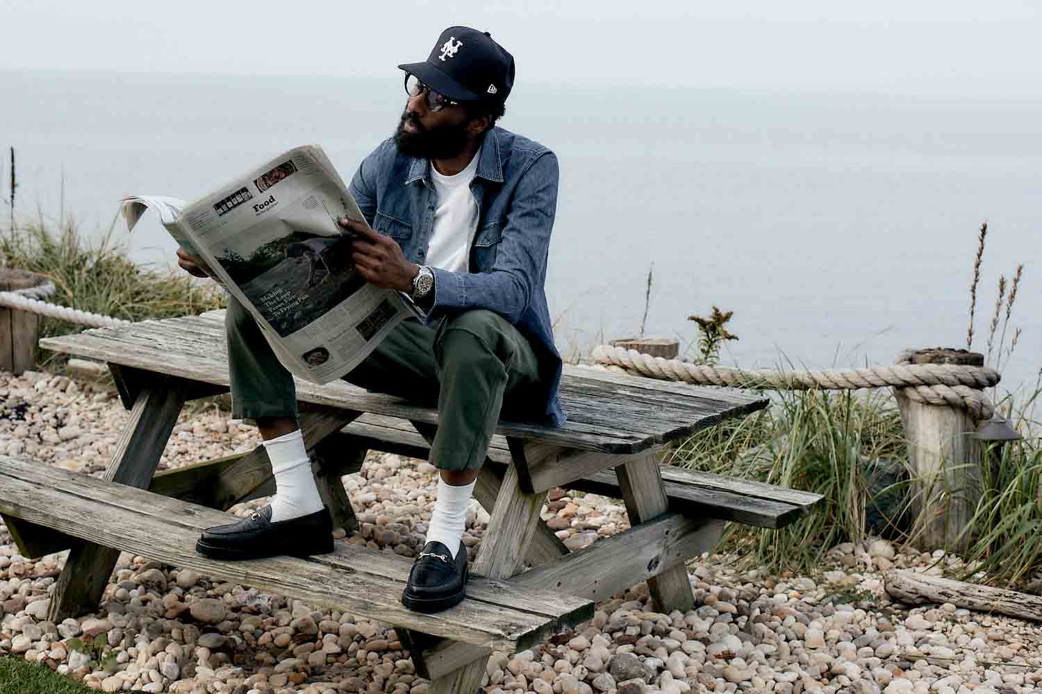 a model wearing Blackstock & Weber loafers against an ocean background