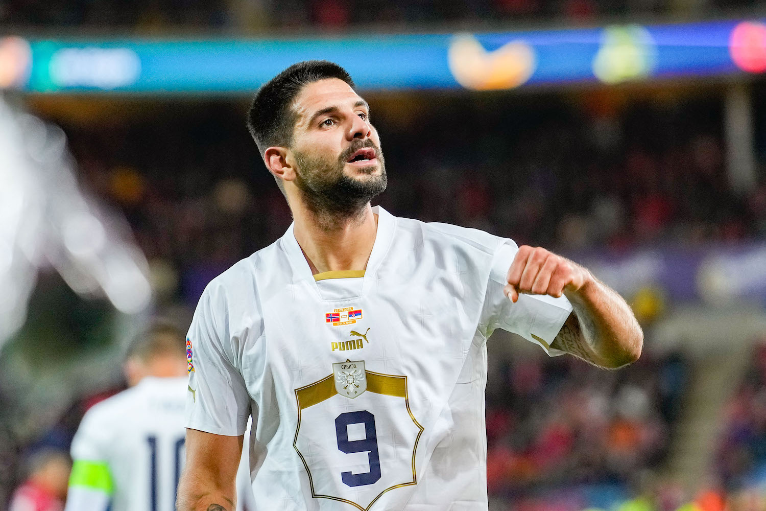 a soccer player wearing a white jersey
