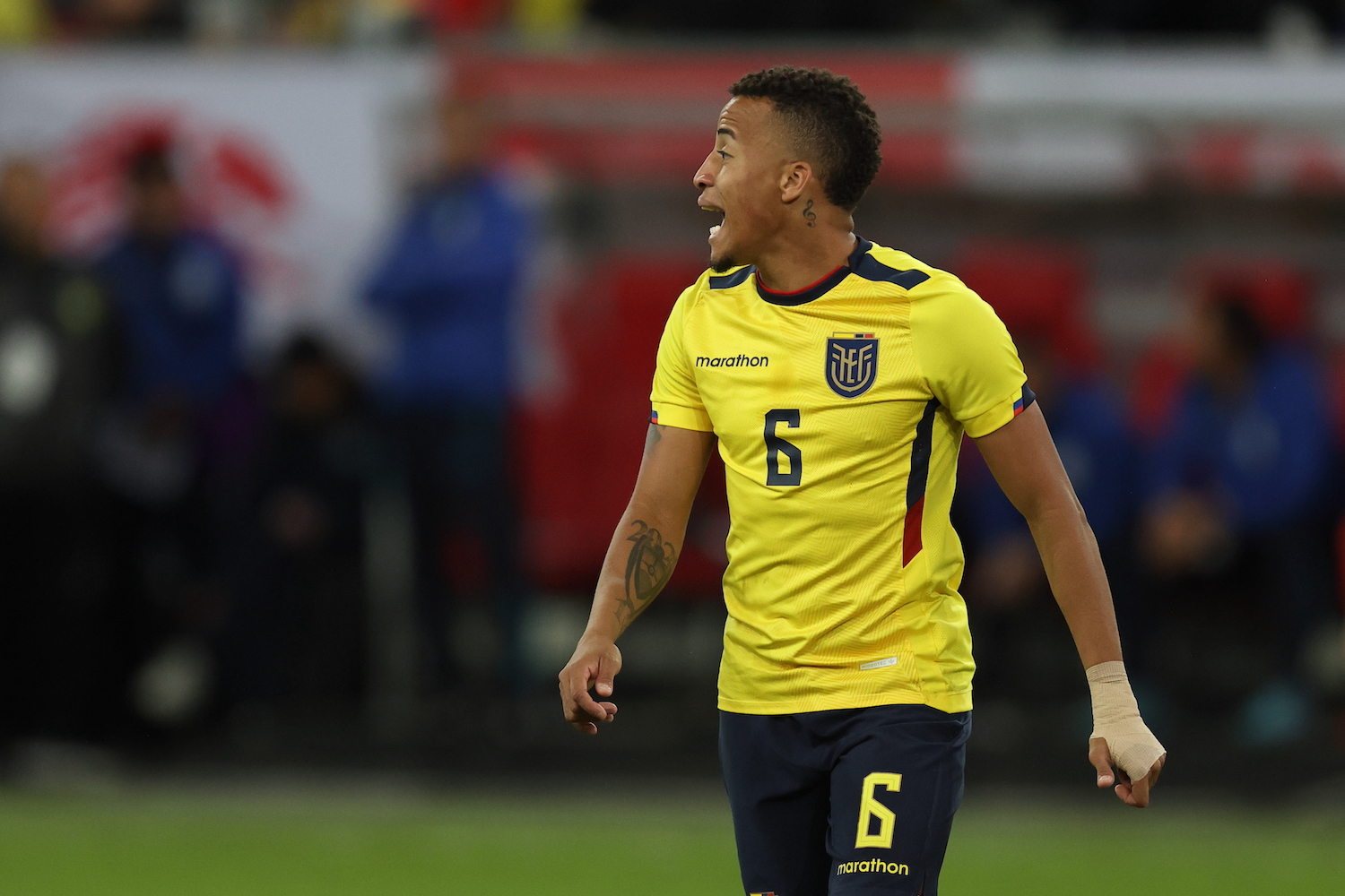 a player in a yellow soccer jersey