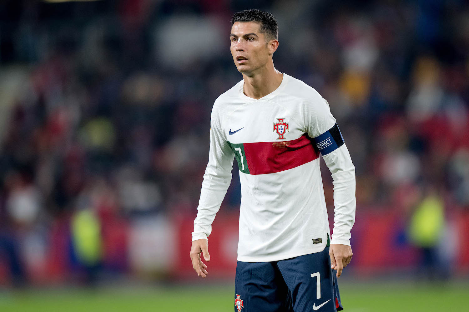 a soccer player in a white patterned soccer jersey