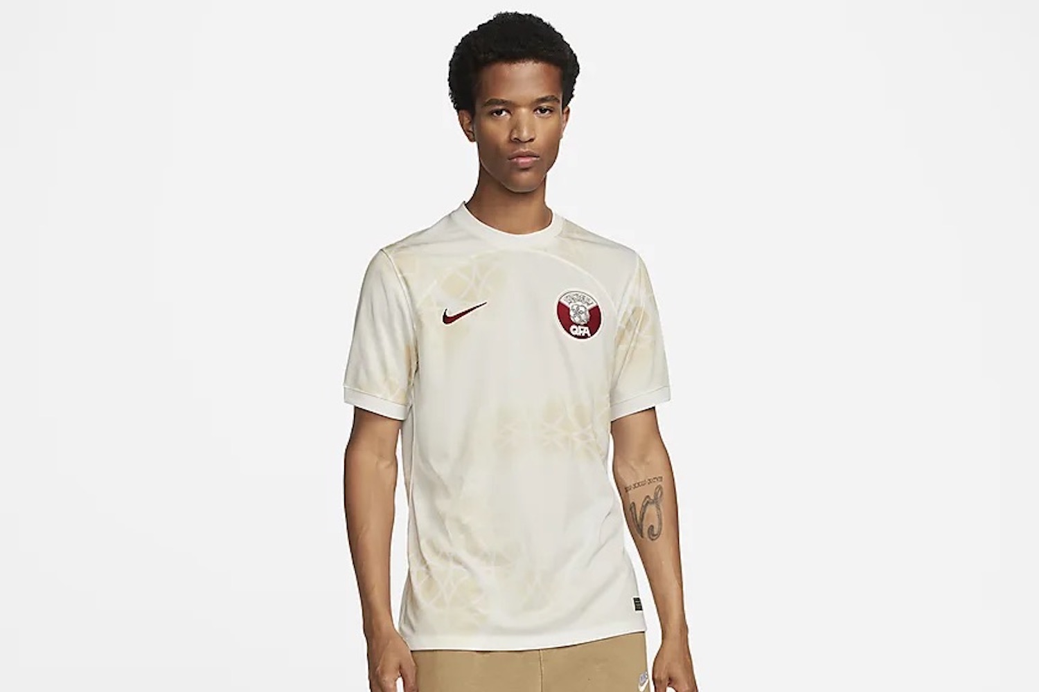 a model wearing the white Qatar away kit