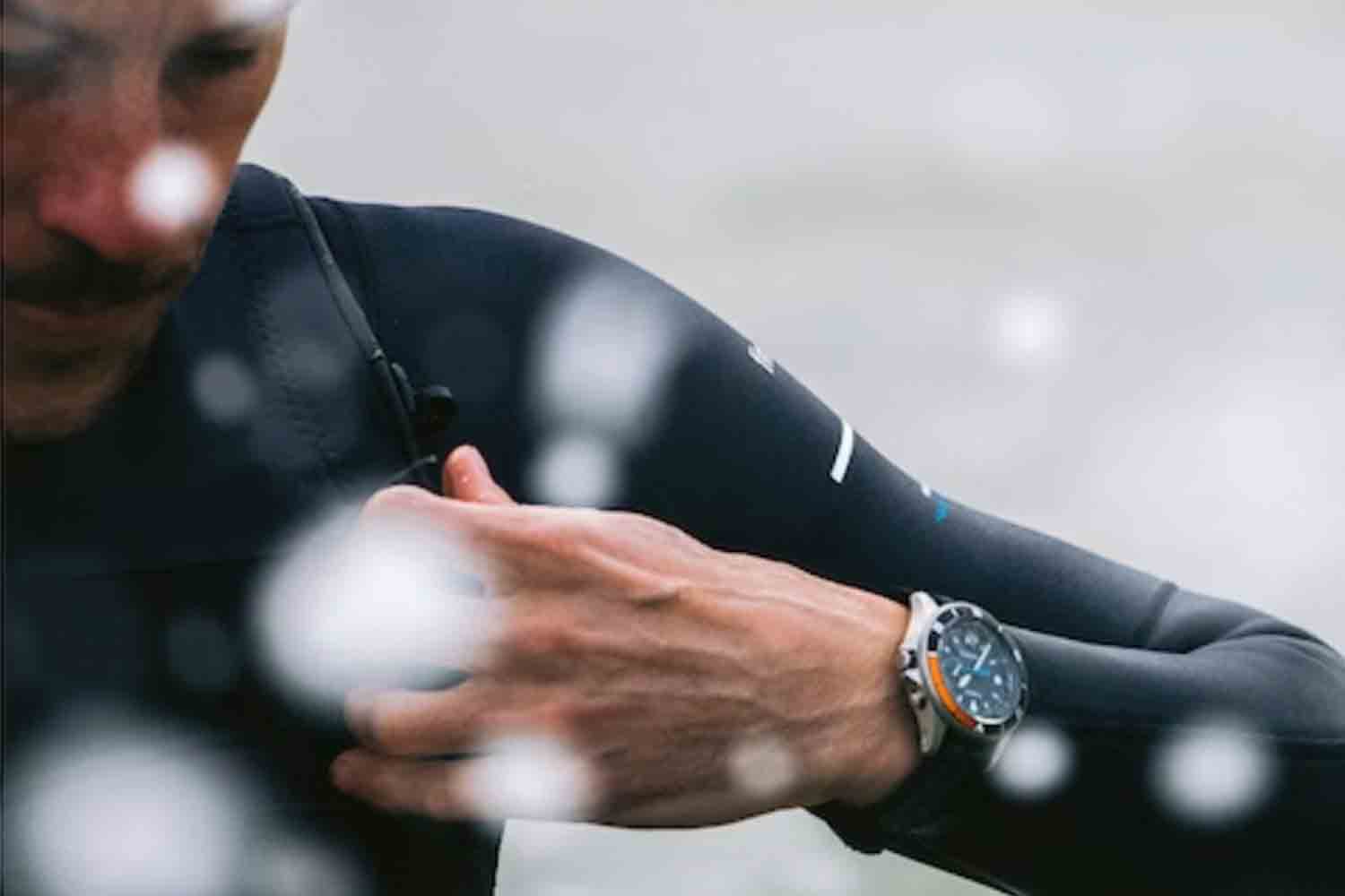 a model wearing the TImex x Finesterre watch in the ocean
