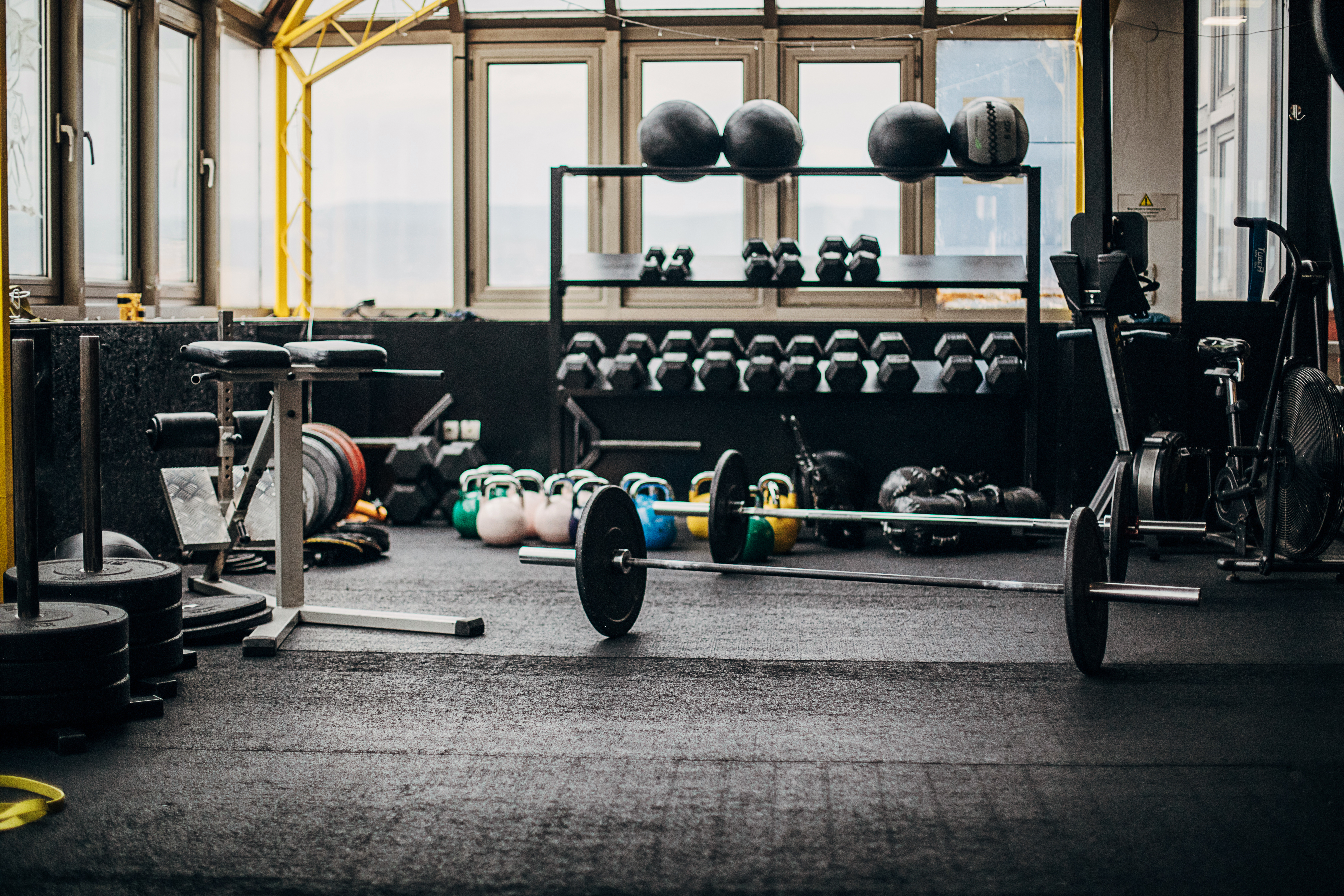 An empty gym with equipment scattered throughout.