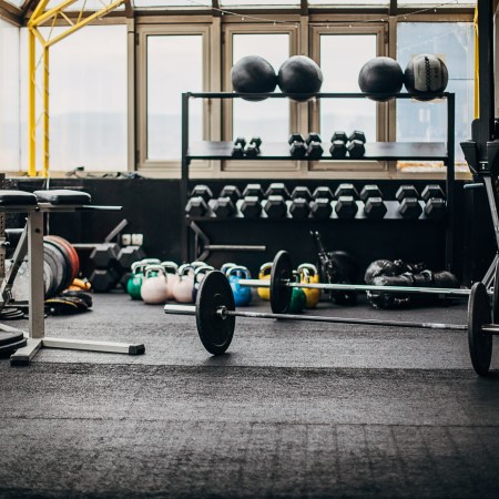 An empty gym with equipment scattered throughout.