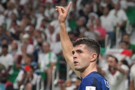 Christian Pulisic takes a corner kick against Iran.