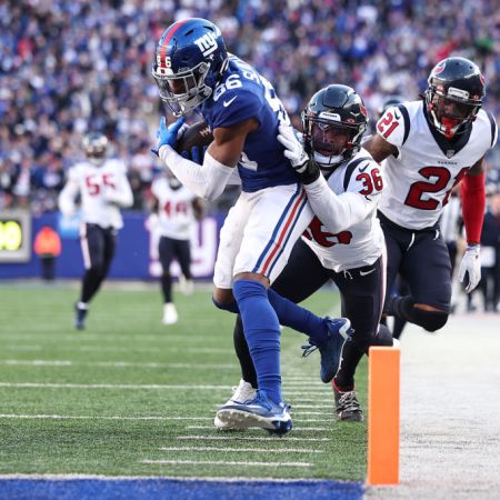 Darius Slayton of the New York Giants scores a touchdown during the third quarter while defended by Jonathan Owens of the Houston Texans at MetLife Stadium.