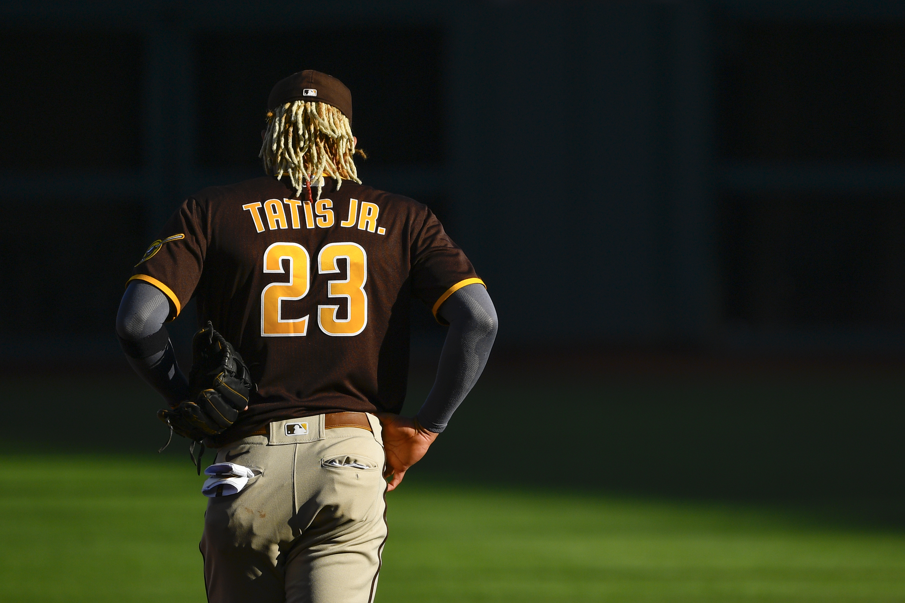 Fernando Tatis Jr. walking onto the field for the San Diego Padres, who just signed a new shortstop