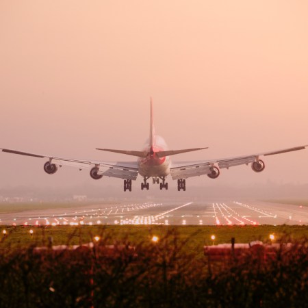 Boeing 747 airplane Landing into sunset
