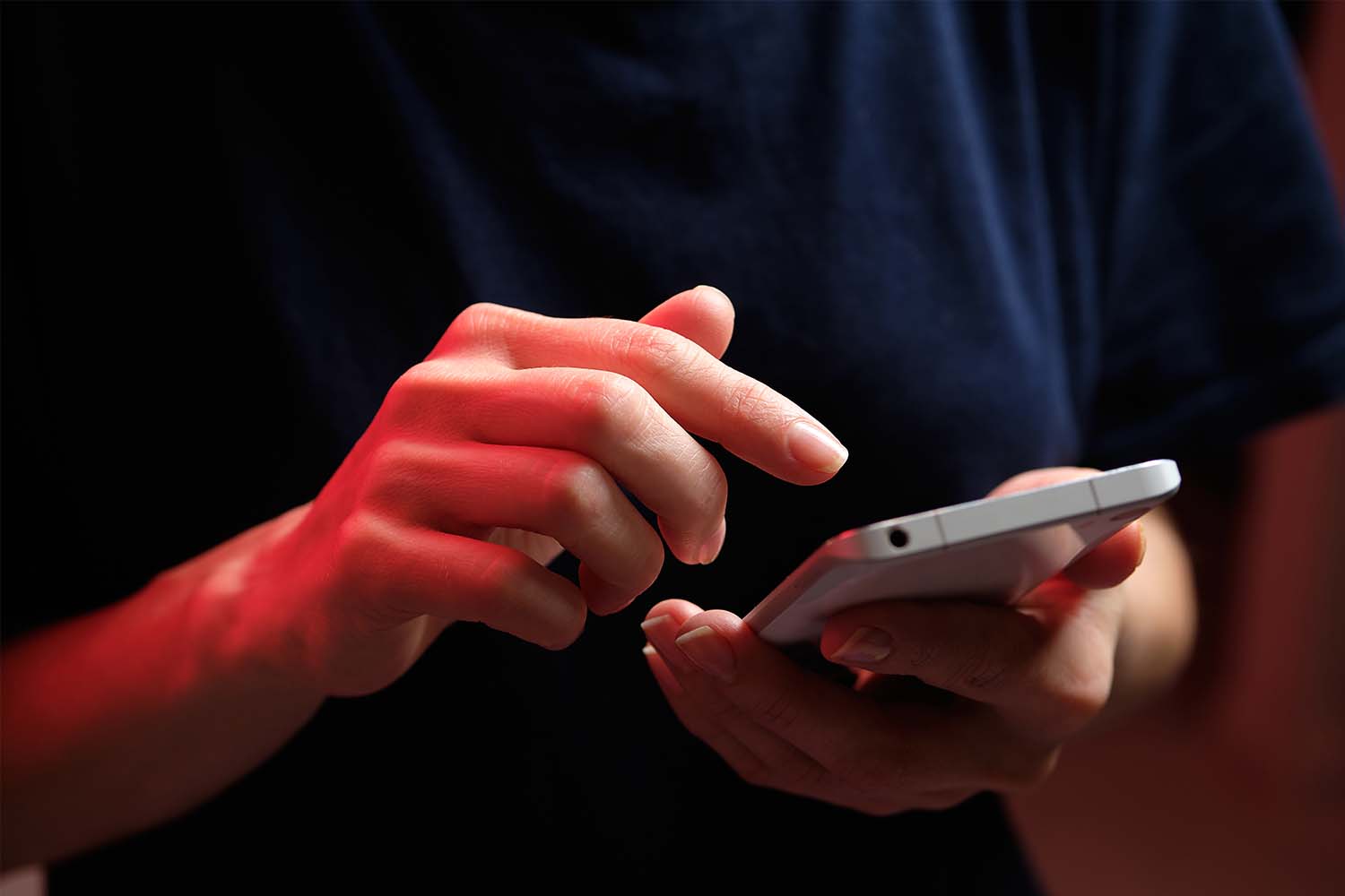 A person texting on a smartphone. The TSA now offers flyers the option to text to ask what's allowed in their carry-on bags.