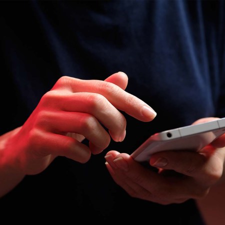 A person texting on a smartphone. The TSA now offers flyers the option to text to ask what's allowed in their carry-on bags.