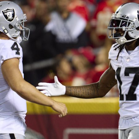 Davante Adams celebrates with Derek Carr after scoring a touchdown.