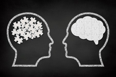 A pictograph of brains with puzzles, one is scrambled and one is assembled.