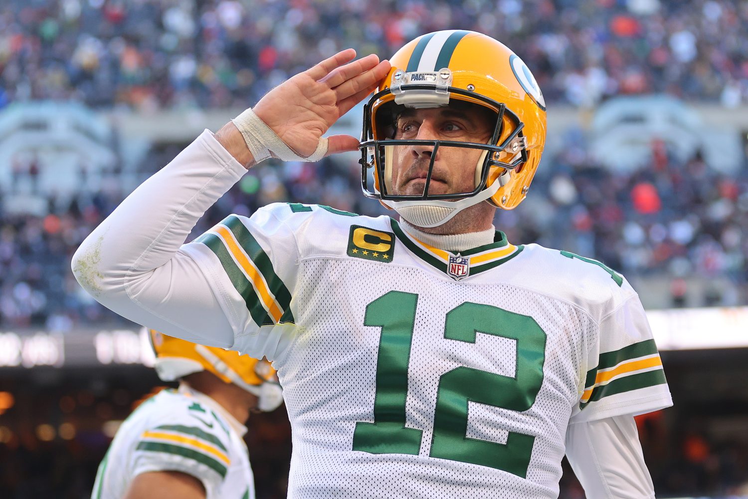 Aaron Rodgers of the Green Bay Packers gives a salute while on the field