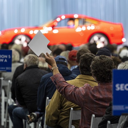An attendee bidding at Gooding & Company’s Pebble Beach auction in August. According to Hagerty, collector cars are finally cooling off.