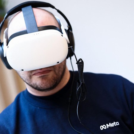 A Meta worker uses a Meta Quest VR headset at the Meta showroom in Brussels on December 07, 2022. Consumer sales of VR headsets were down in 2022, sparking concerns about interest in the metaverse.