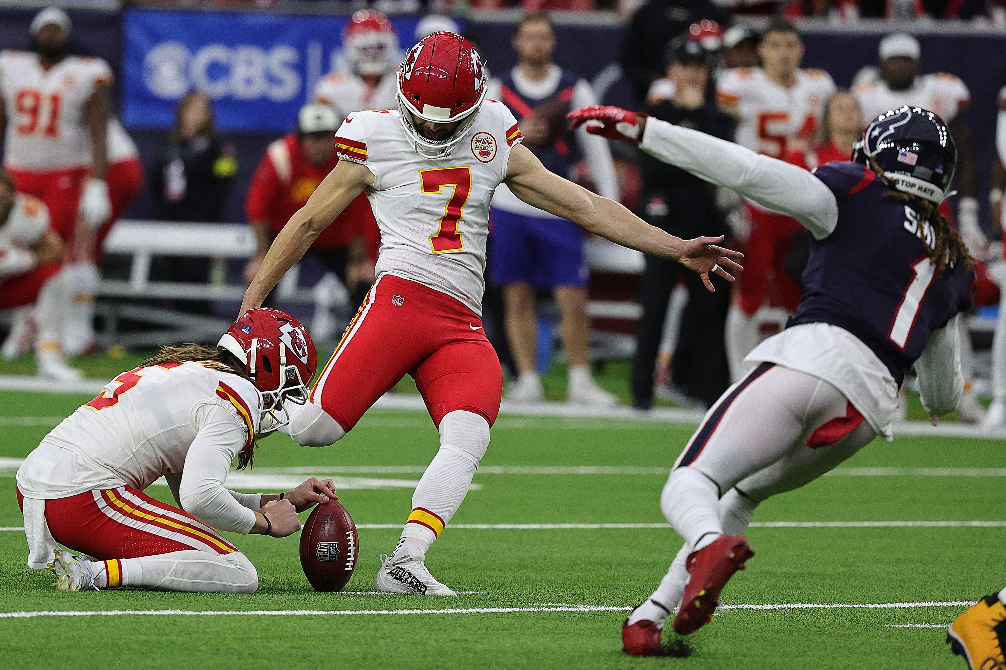 Harrison Butker of the Chiefs kicks a field goal in OT against the Texans.