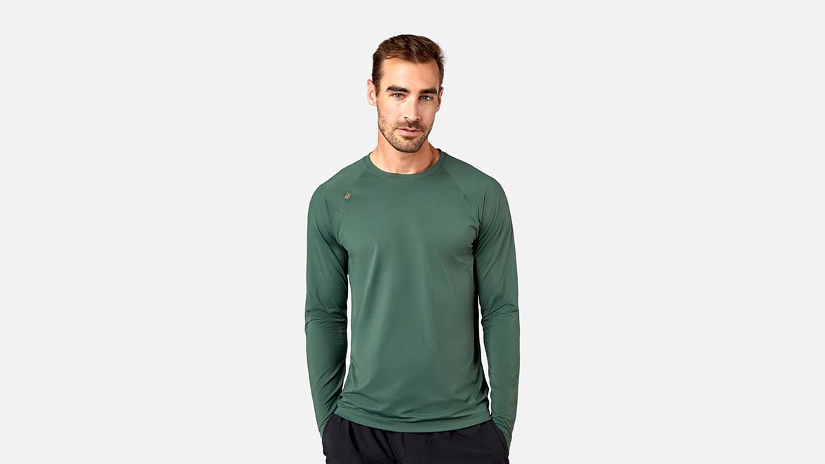 A man wearing the Reign Long Sleeve by Rhone. The activewear brand is taking up to 60% off hundreds of styles.