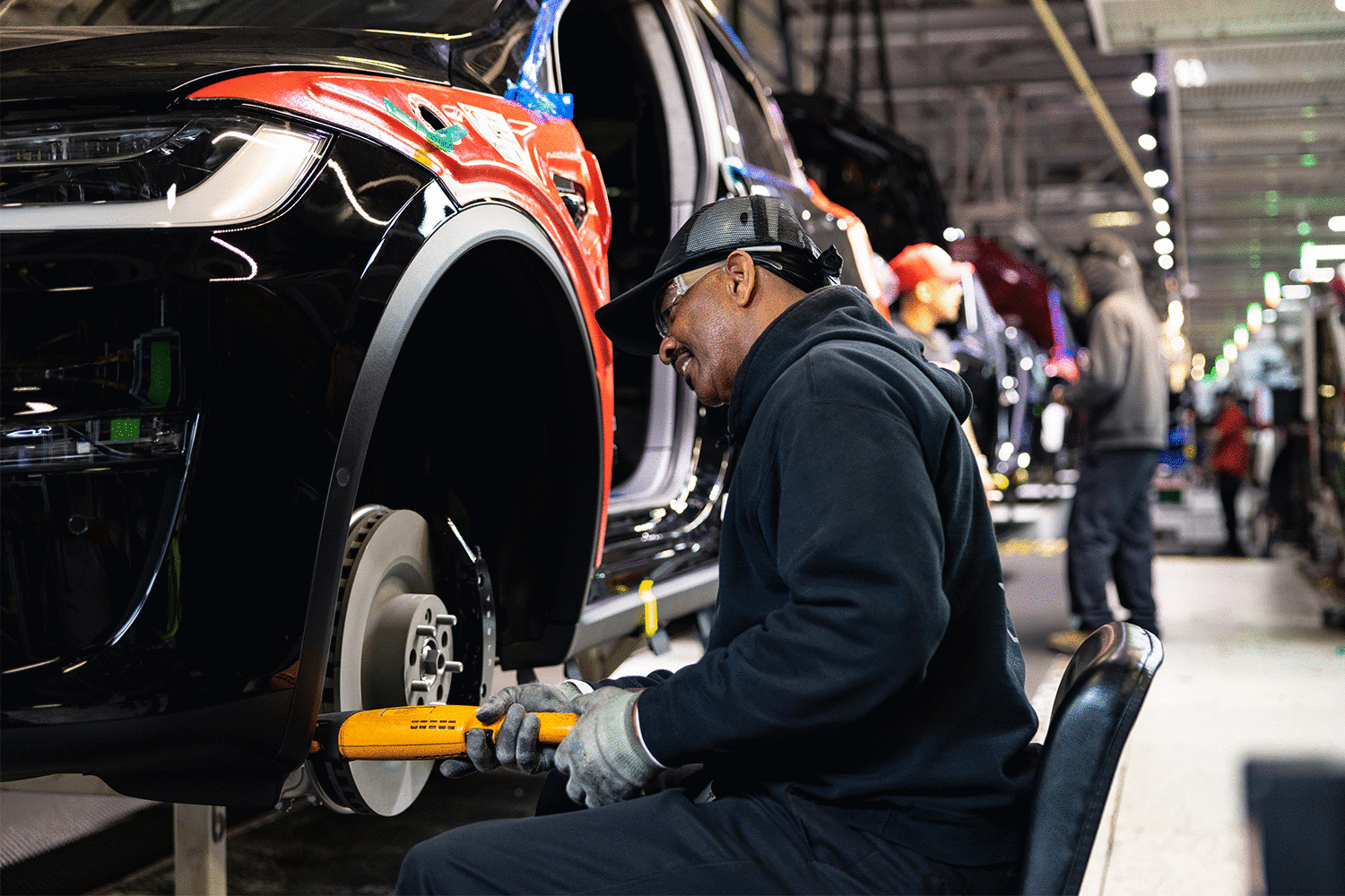 A Tesla factory worker in the EV company's Fremont, California factory. Elon Musk's company just became the luxury sales leader in the U.S. in 2022.