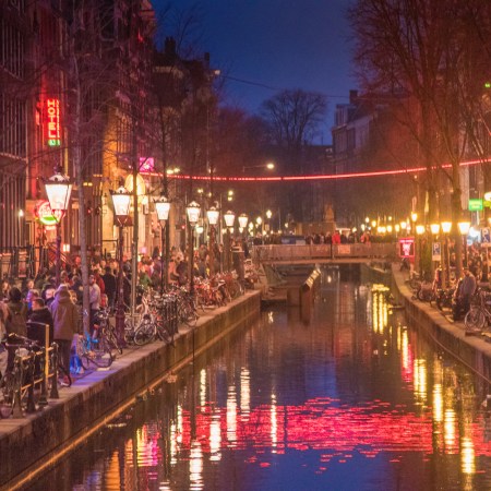 Red light destrict view and Amsterdam canal, bicycles and cyclists