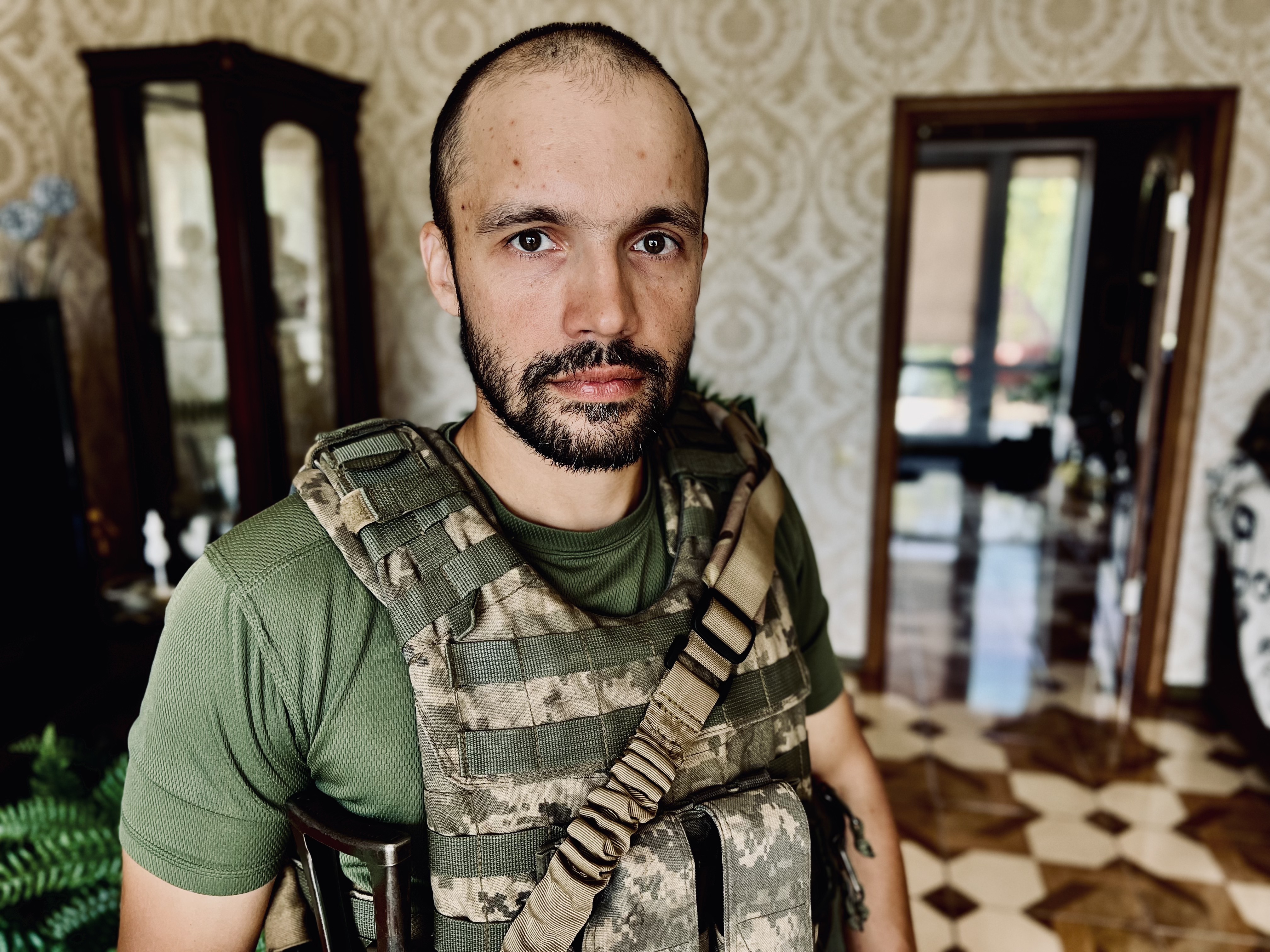 man in flak jacket and army fatigues