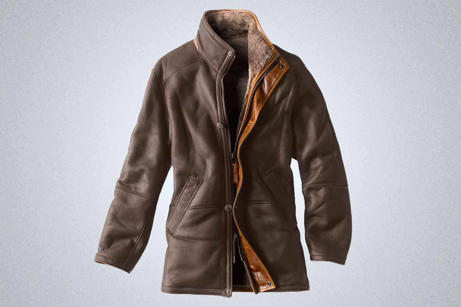 a dark brown Orvis leather shearling jacket on a grey background