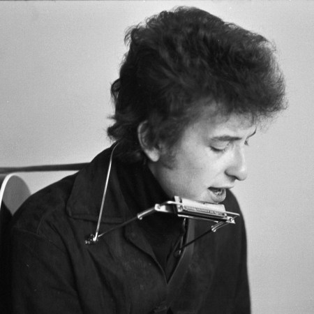 black and white photo of Bob Dylan with a harmonica