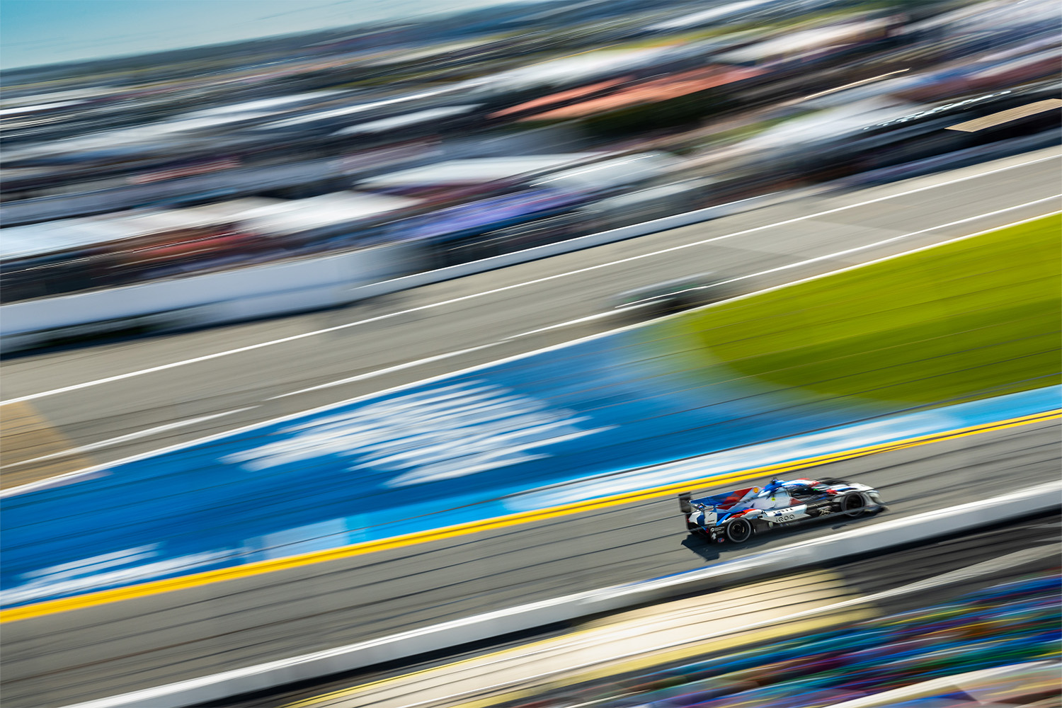 The BMW M Team RLL car speeds through the grandstands during Practice 4 at Daytona International Speedway.