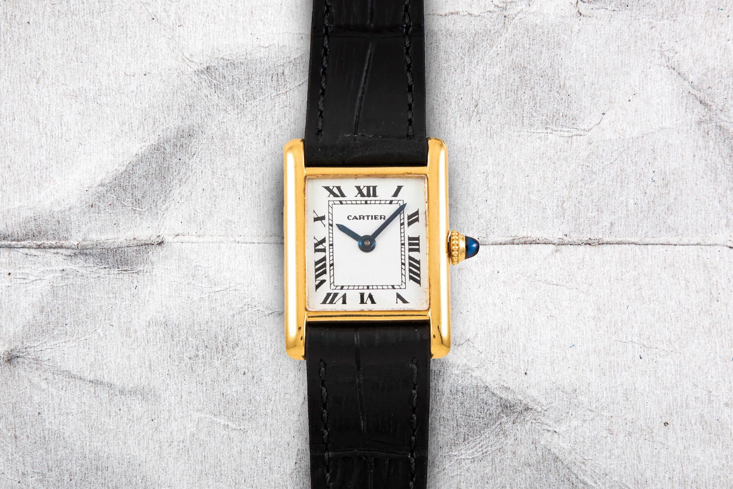 The Cartier Tank Louis on a gray background