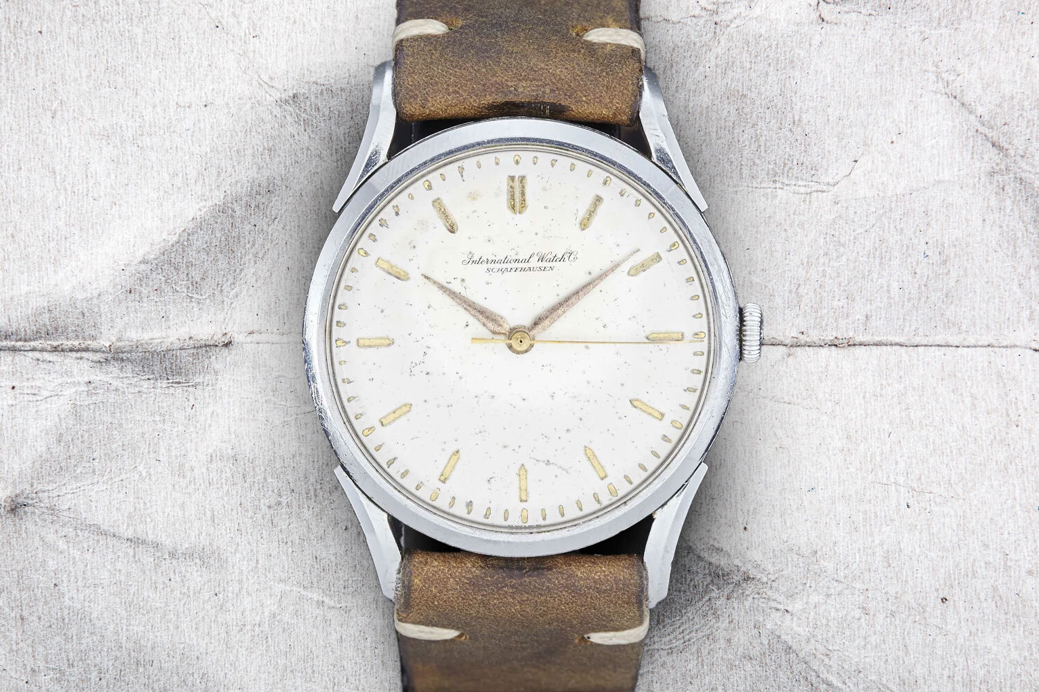 The IWC Caliber 89 on a gray background. A great vintage watch under $10,000.