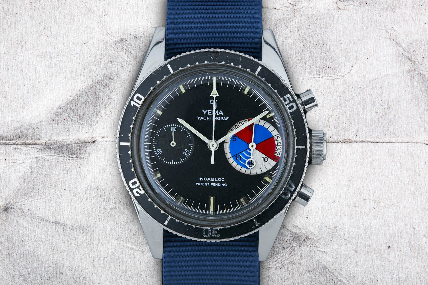Yema Yachtingraf, one of the best vintage watches under $10,000, on a gray background