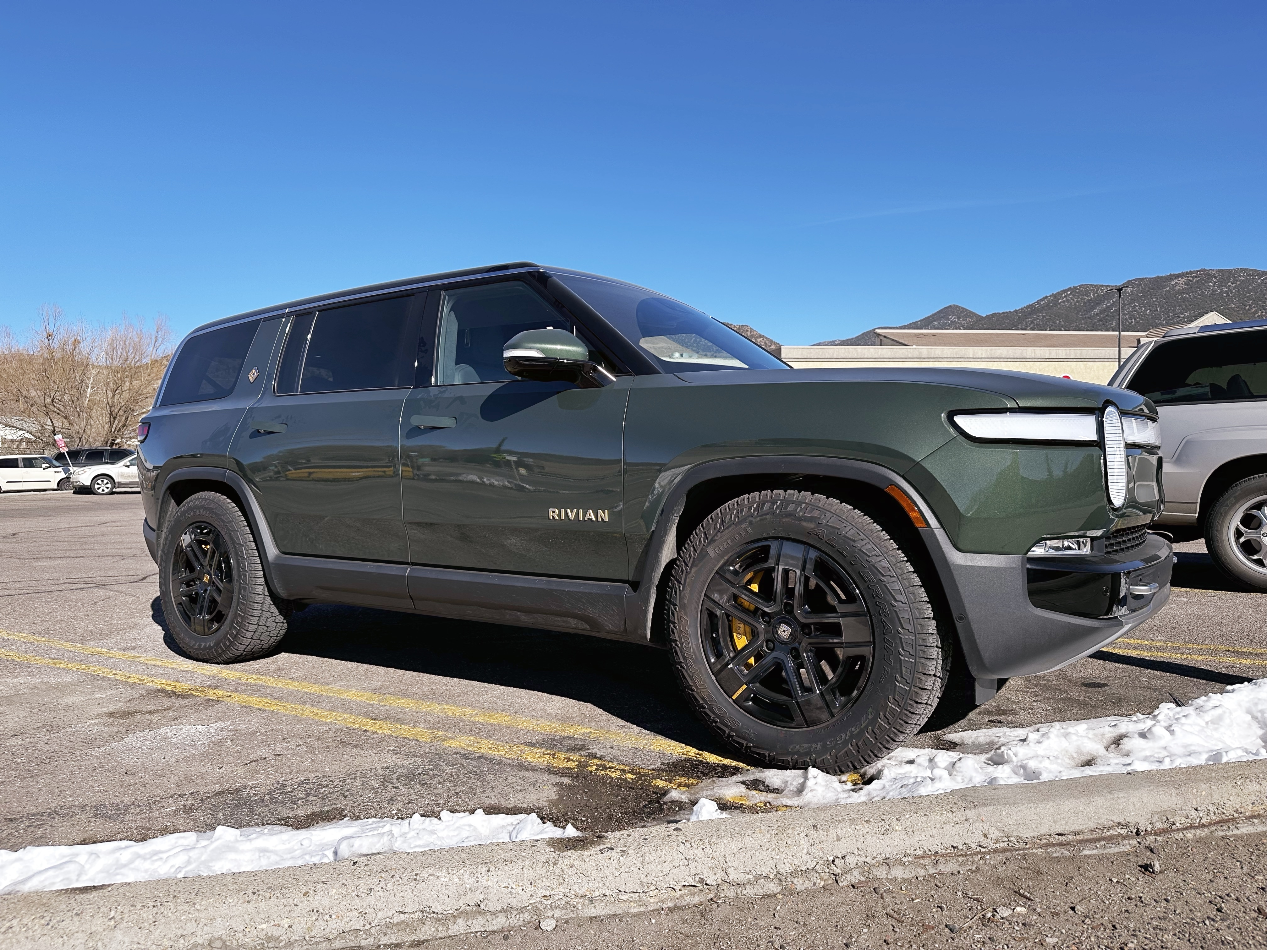 a green rivian suv