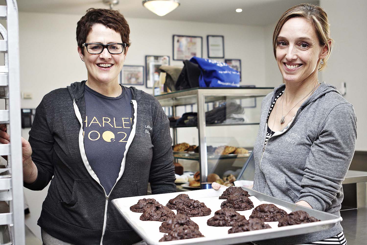 Pam Weekes and Connie McDonald of levain bakery holding a tray of cookies