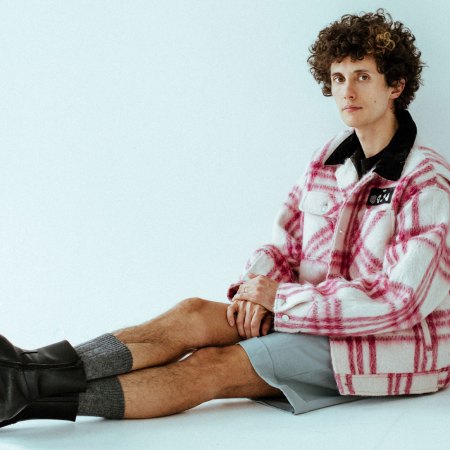 Ron Gallo wearing PHIPPS Chore Coat, Canali Shorts, and Squared Boots.