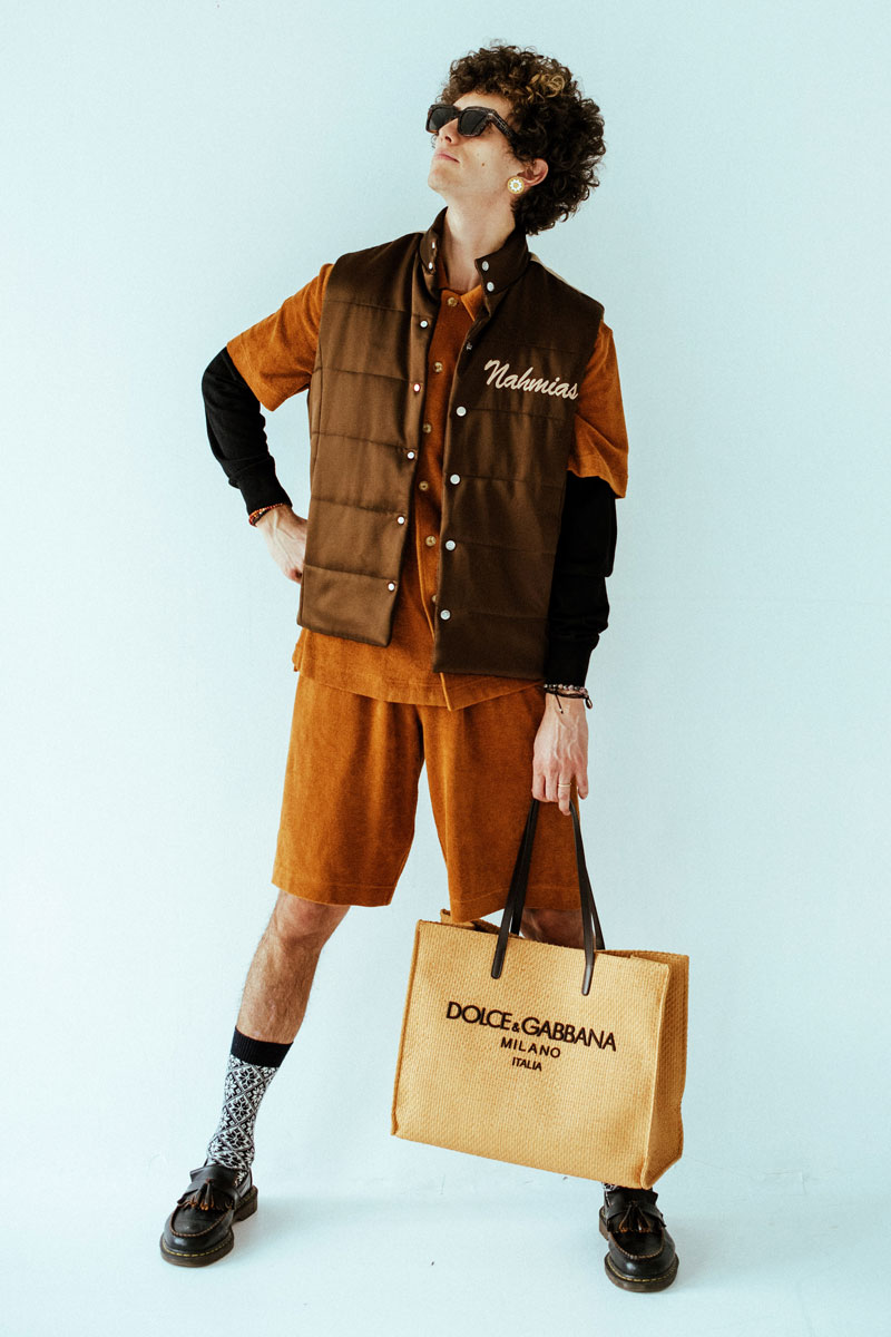 Ron Gallo in a vest and shorts on a light blue background, promoting his new album FOREGROUND