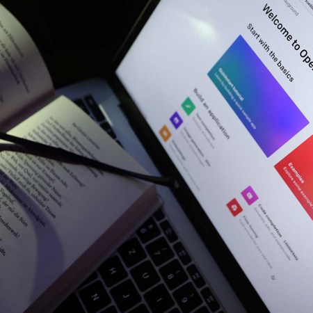 A book of poems lies on a screen on which the homepage of ChatGPT is called up. ChatGPT is being used to write books that are available on Amazon.